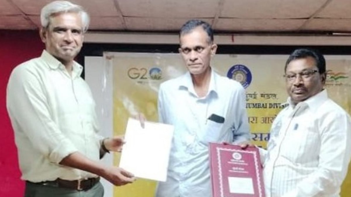 Niraj Verma, Divisional Railway Manager of Mumbai Central Division is seen presenting the retirement documents to one of the employee at the farewell function at Divisional Office.